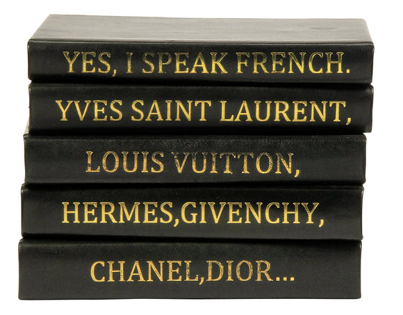 Decorative book stack with I Speak French quote on Muted